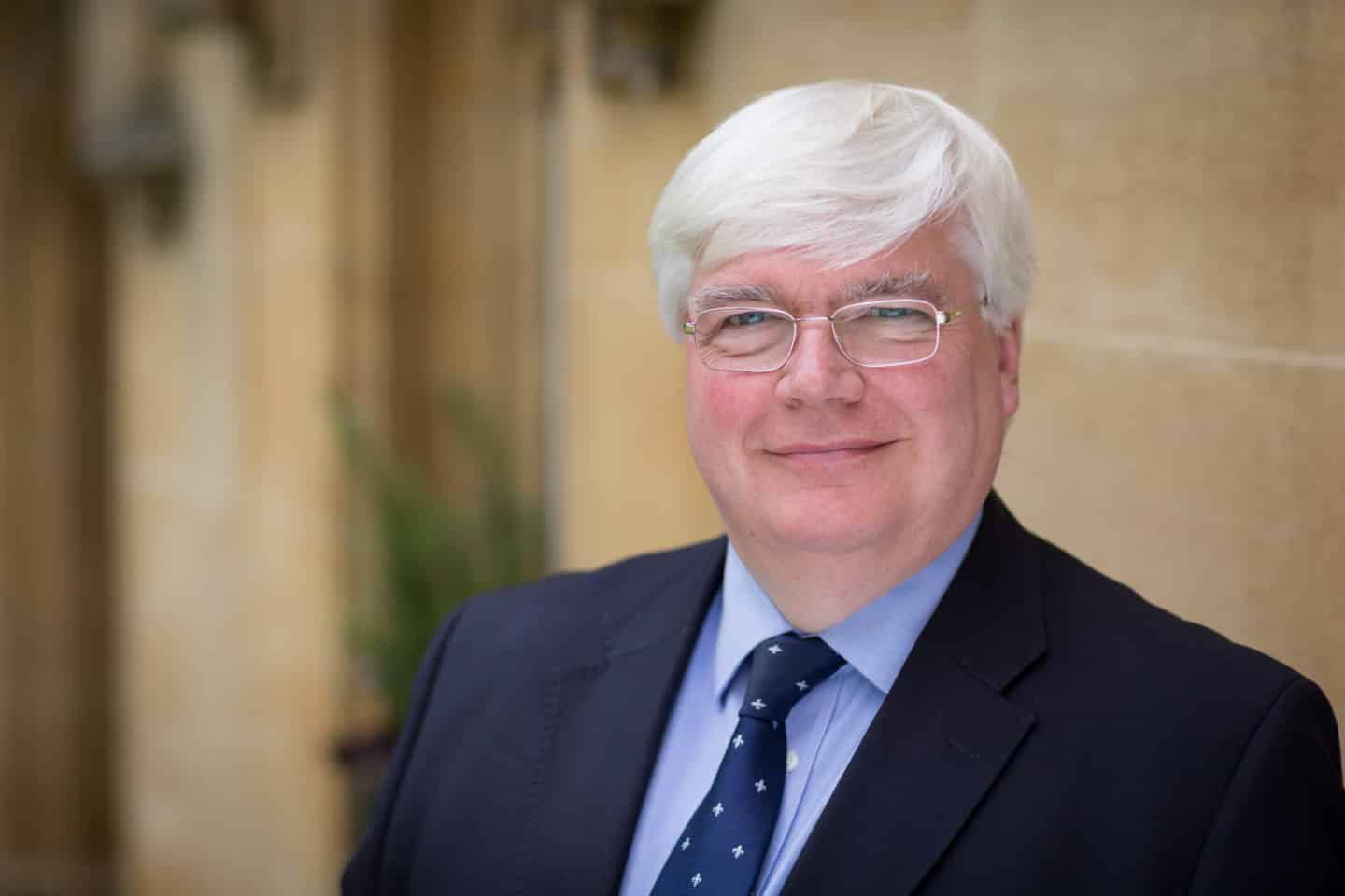 Headshot of Professor David Vaux, a man in a suit and tie and wearing glasses