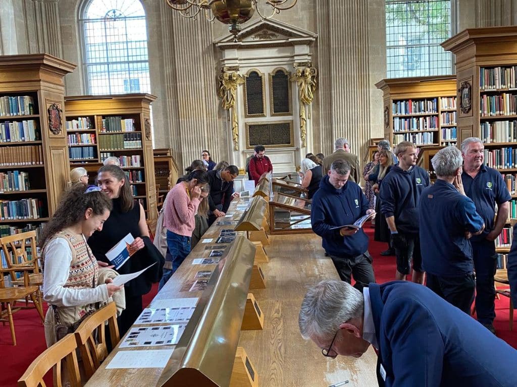 Staff exploring displays in Lincoln College Library during the 50th anniversary event