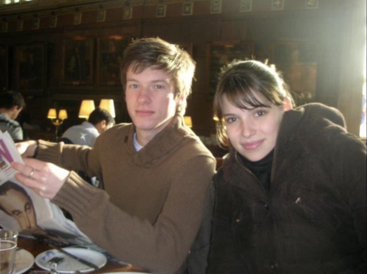 Alumna Julia Whelan with a man in the College dining hall.