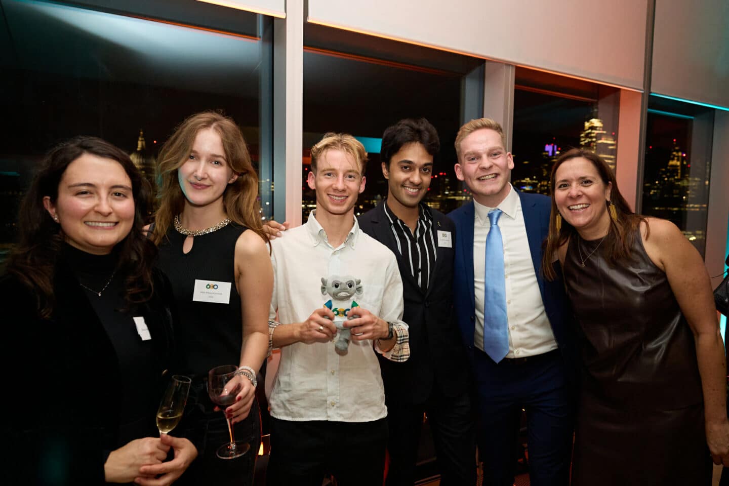 Students and alumni holding an imp at the 600 campaign launch