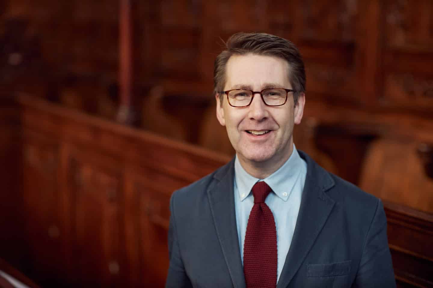 Headshot of Dr Mark Kirby, a man in a suit and tie and wearing glasses