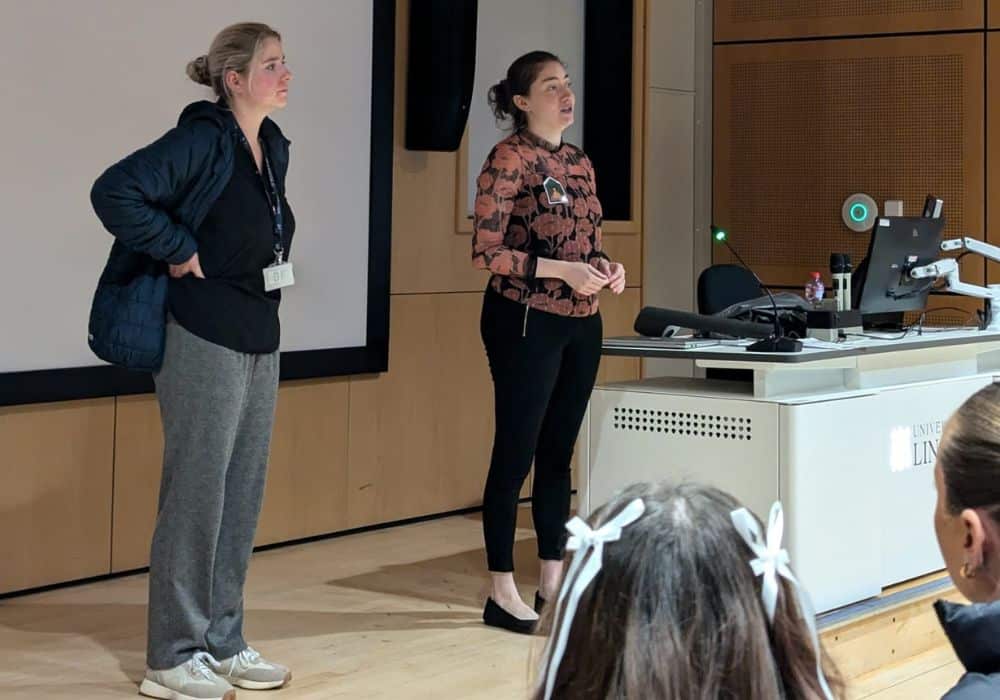 Photo of Maryanne Saunders and another woman speaking to students