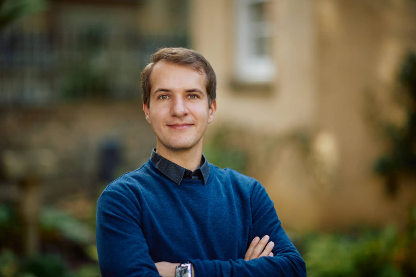 Headshot of Andrii Gorelik, a young man dressed in blue.