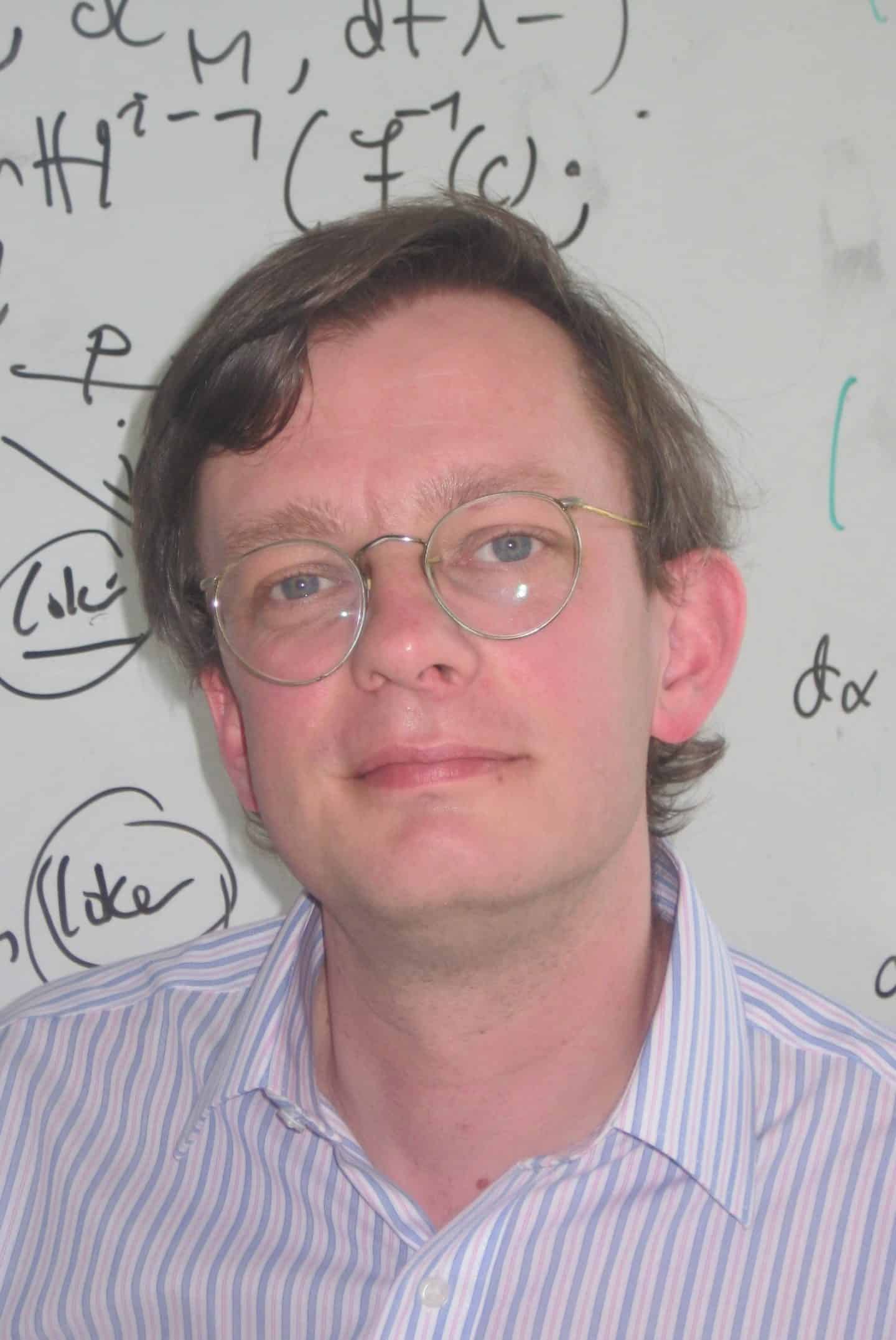 Headshot of Professor Dominic Joyce, a man in a shirt and glasses