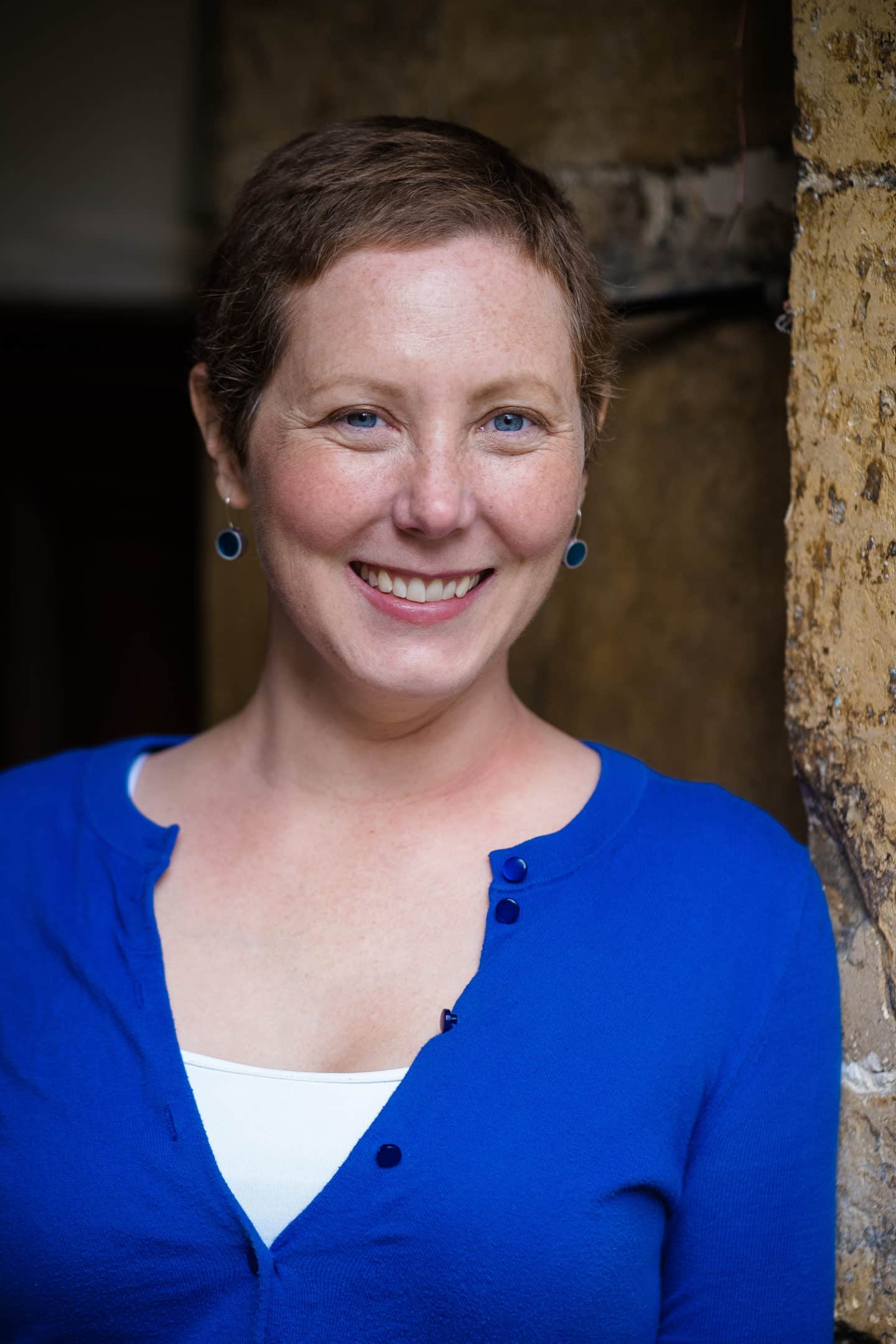 Headshot of Dr Jody LaPorte, a woman in a blue top and earrings