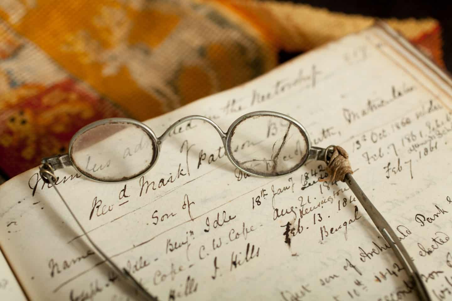 Wesley glasses resting on an open book