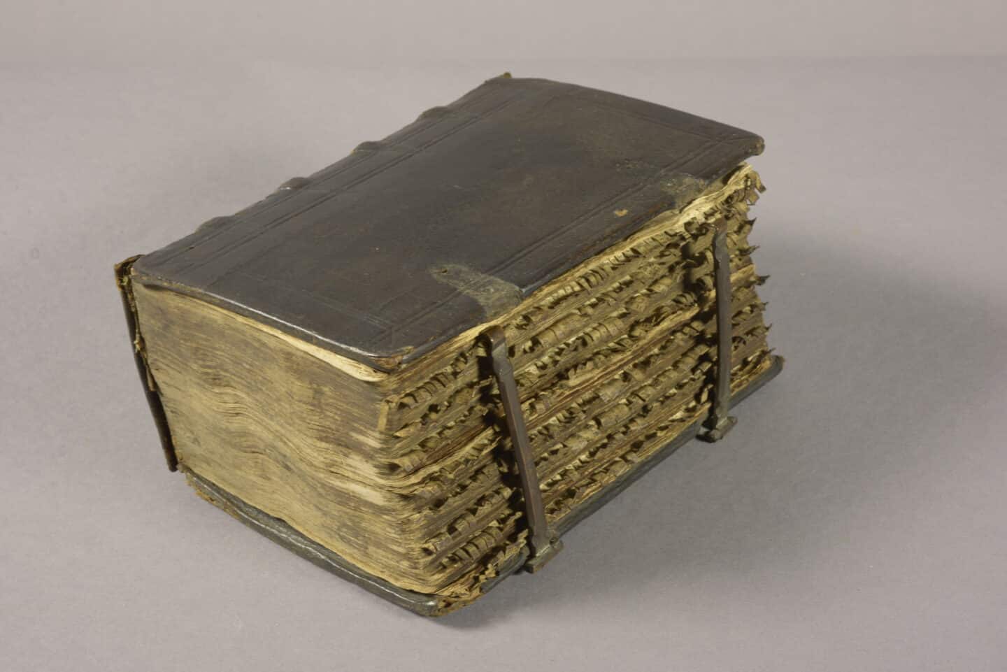 Very thick closed Bible, with numerous parchment tabs sticking out from between the pages