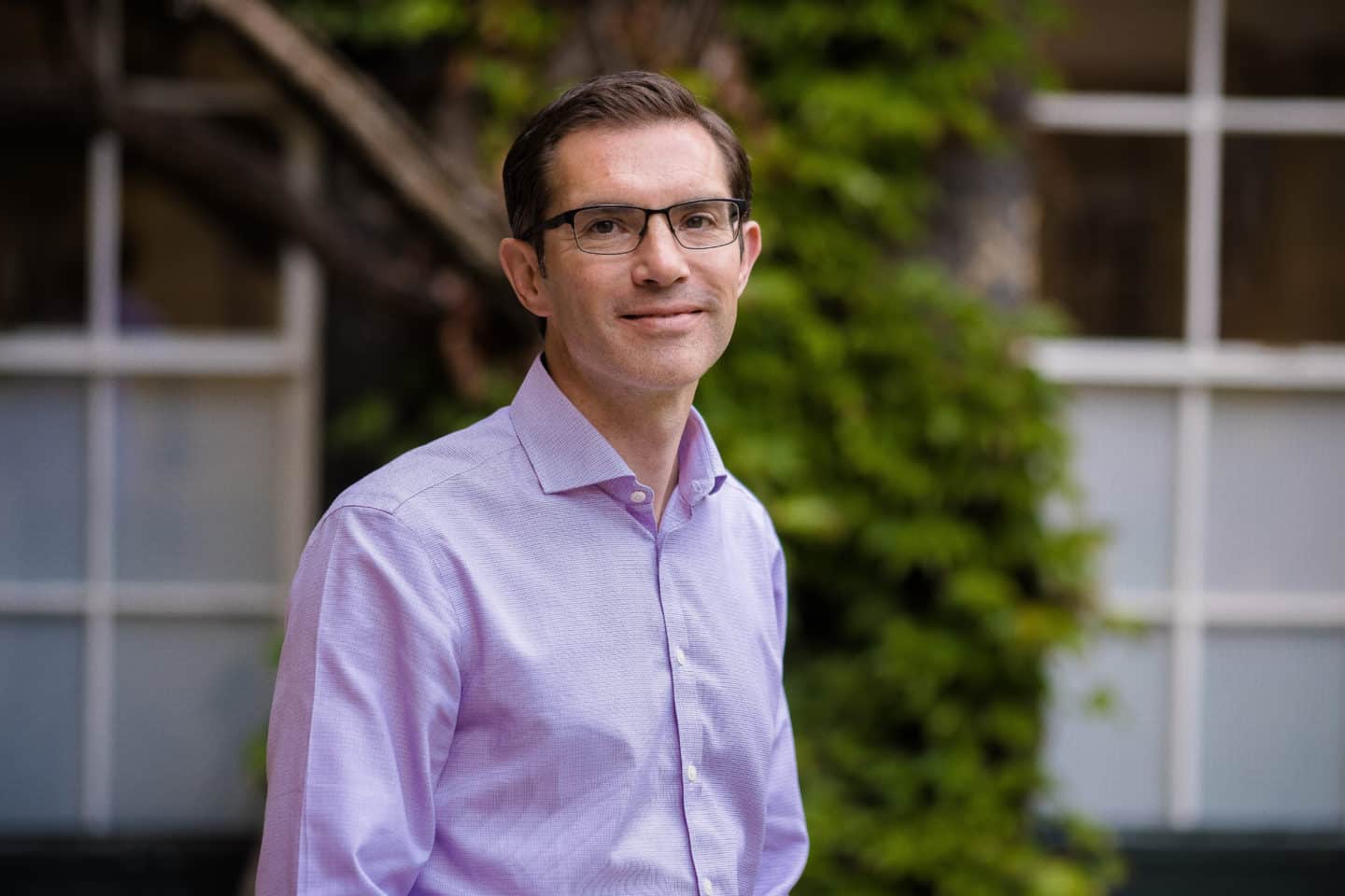 Headshot of Professor Michael Willis, a man in a pink shirt and glasses