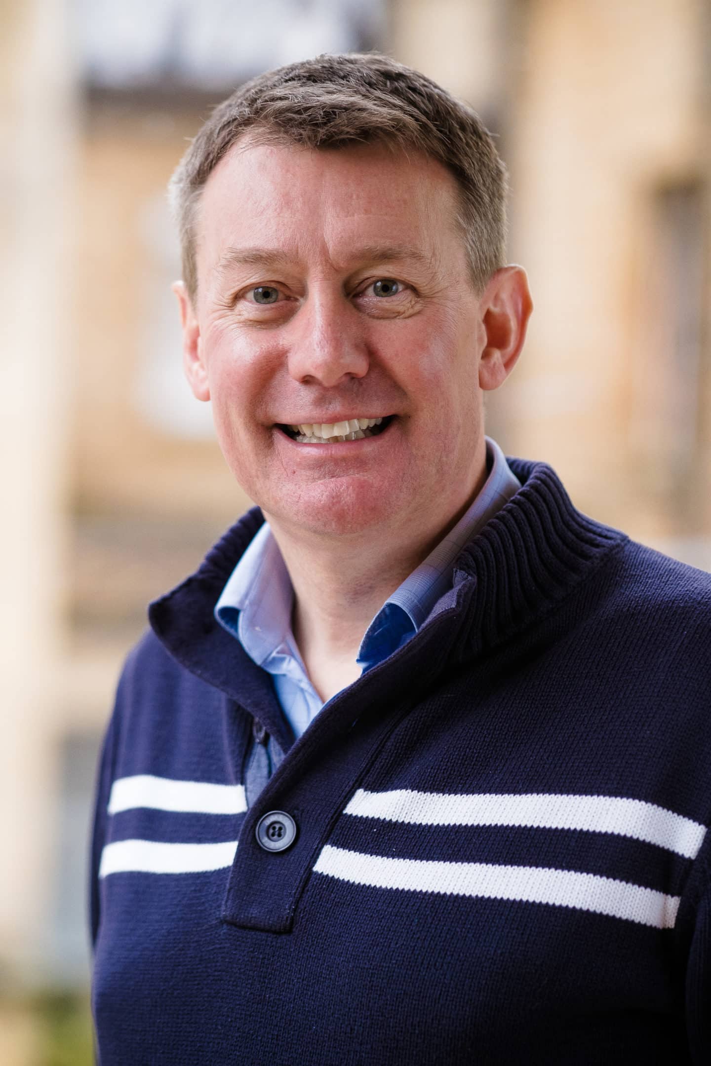 Headshot of Professor Nigel Emptage, a man in a blue shirt and jumper