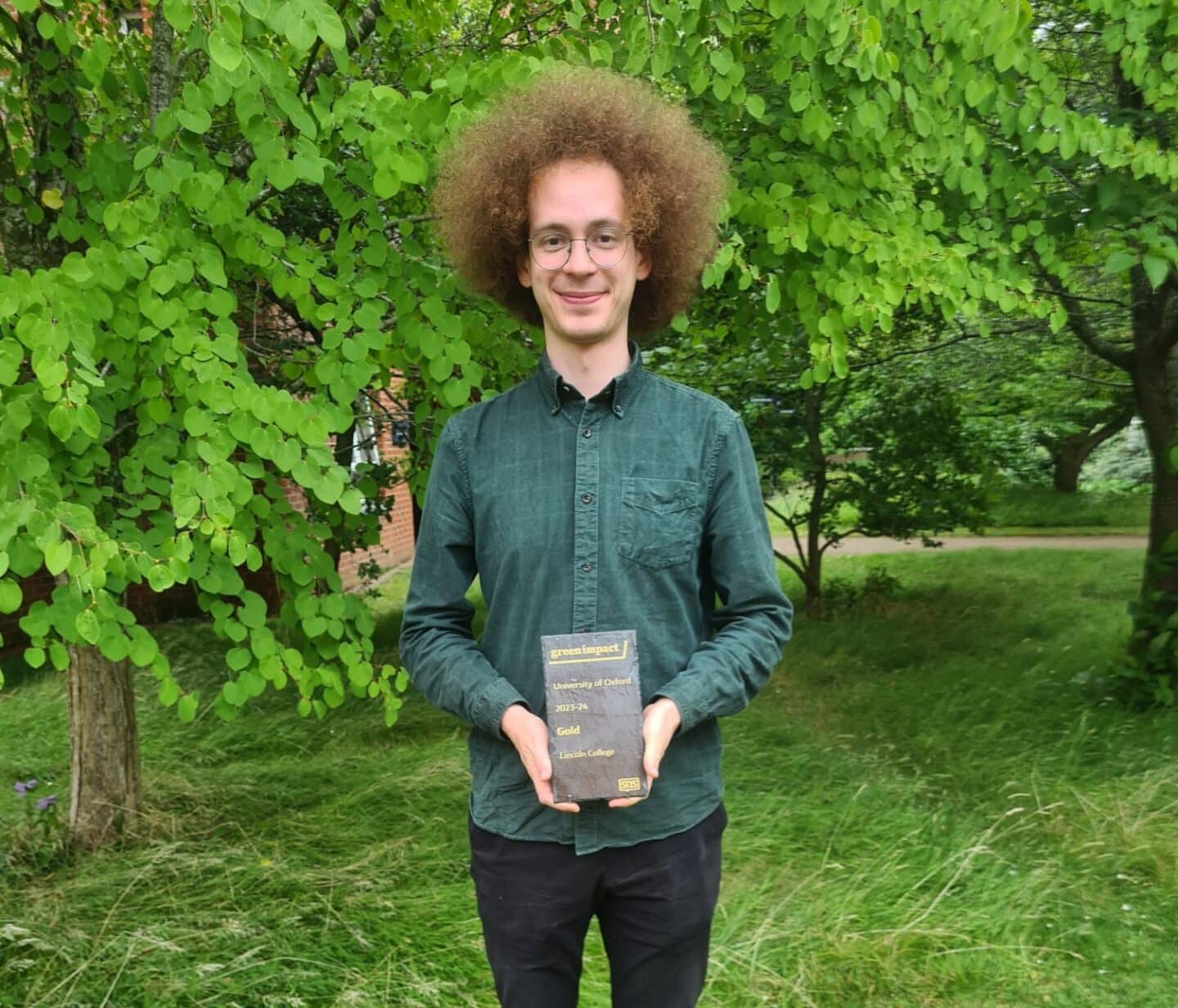 Peter Nitsche-Whitfield holding the award