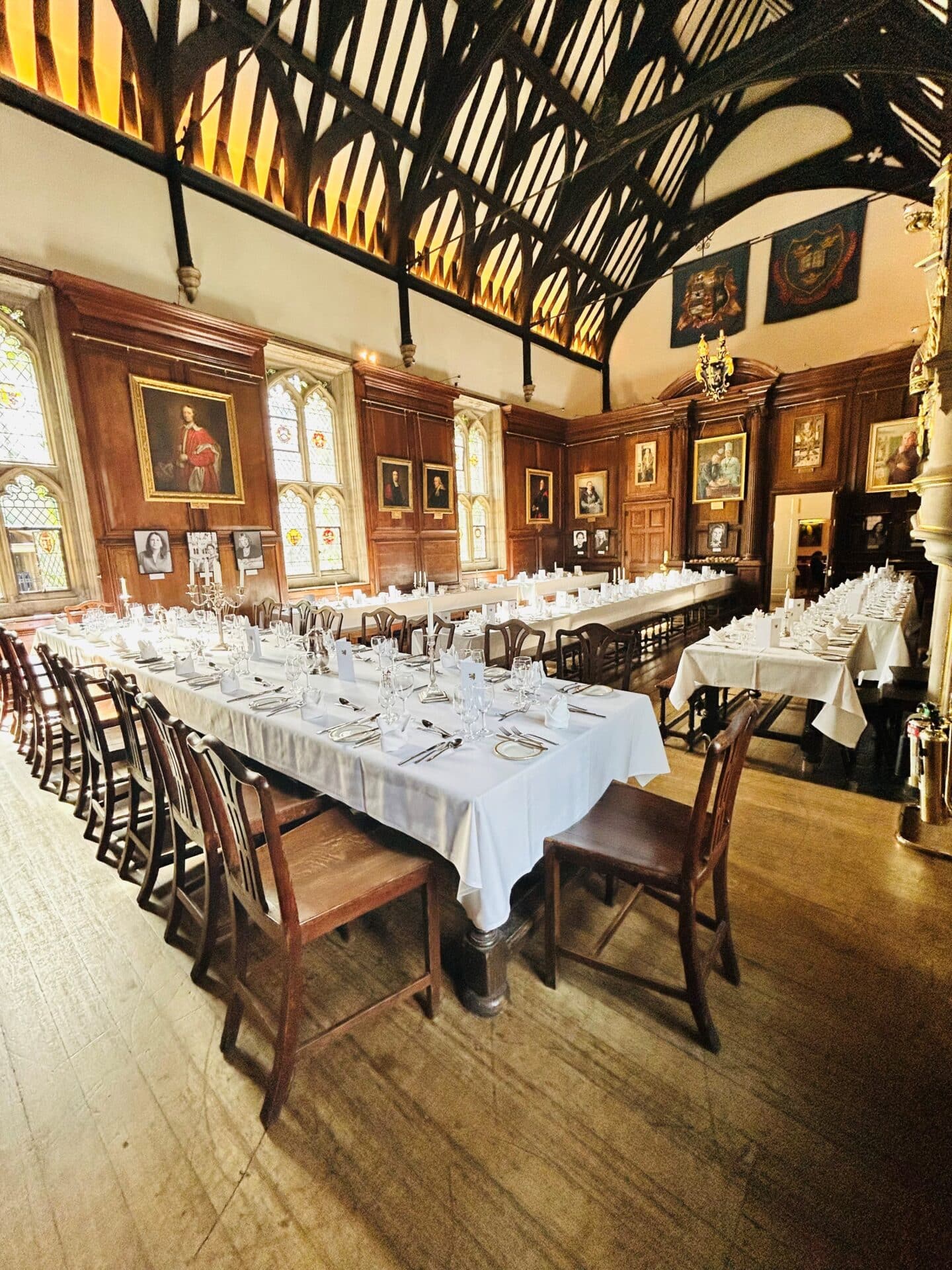 Photograph of the Lincoln College Hall with its tables covered in white tablecloths ready for dinner