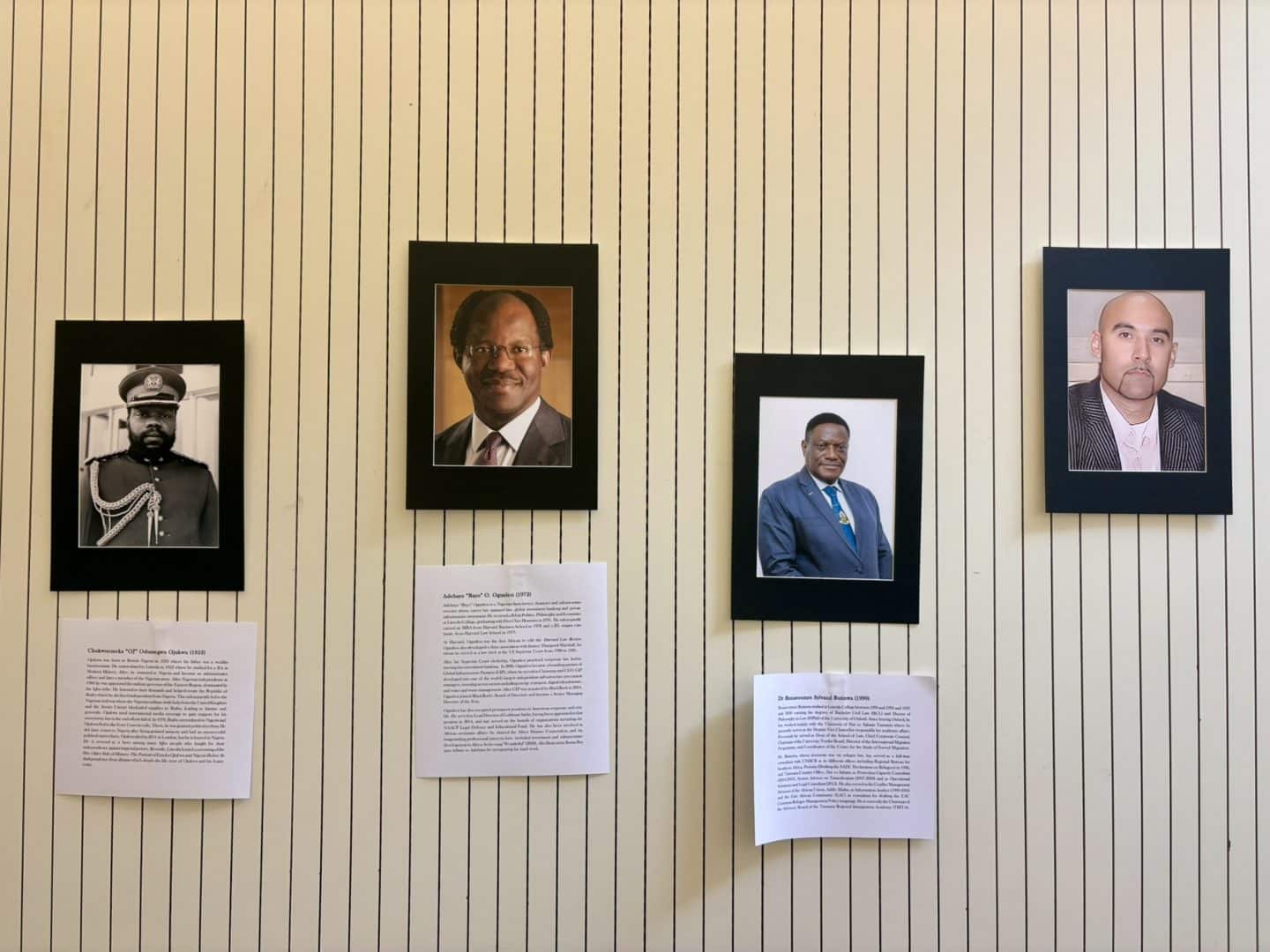 Section of the Black at Lincoln exhibition showing four framed portraits of Black Lincoln alumni and associated figures, with biographical interpretation panels beneath three of the photographs.