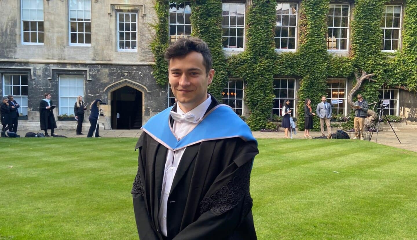 Photo of Robert McDonald in graduation gown in Front Quad
