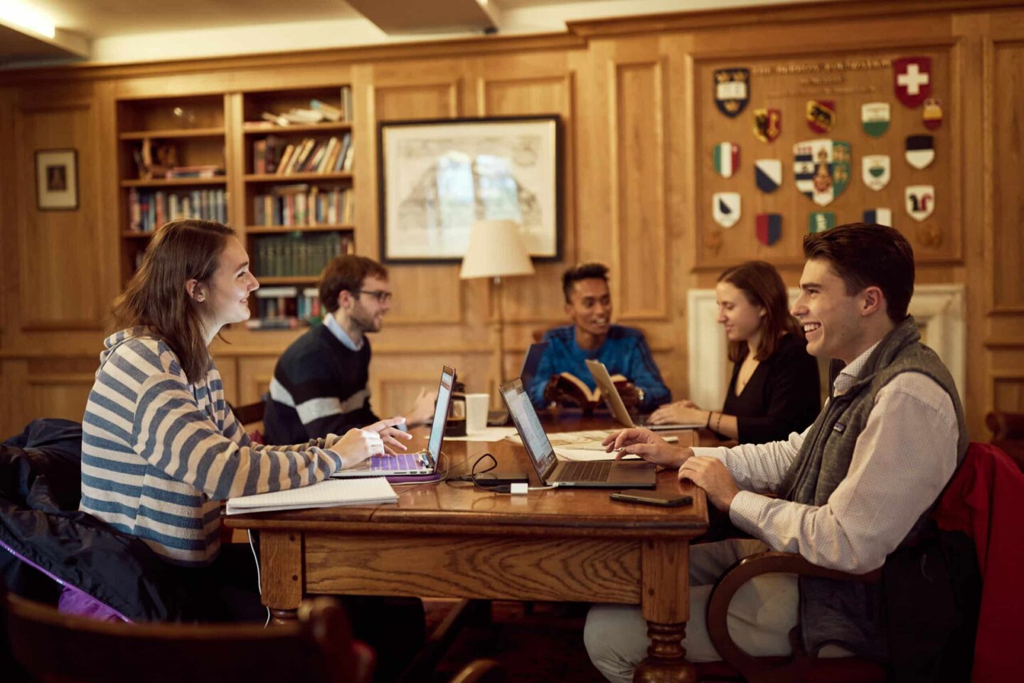 Five students sitting around a table in the Lincoln College MCR