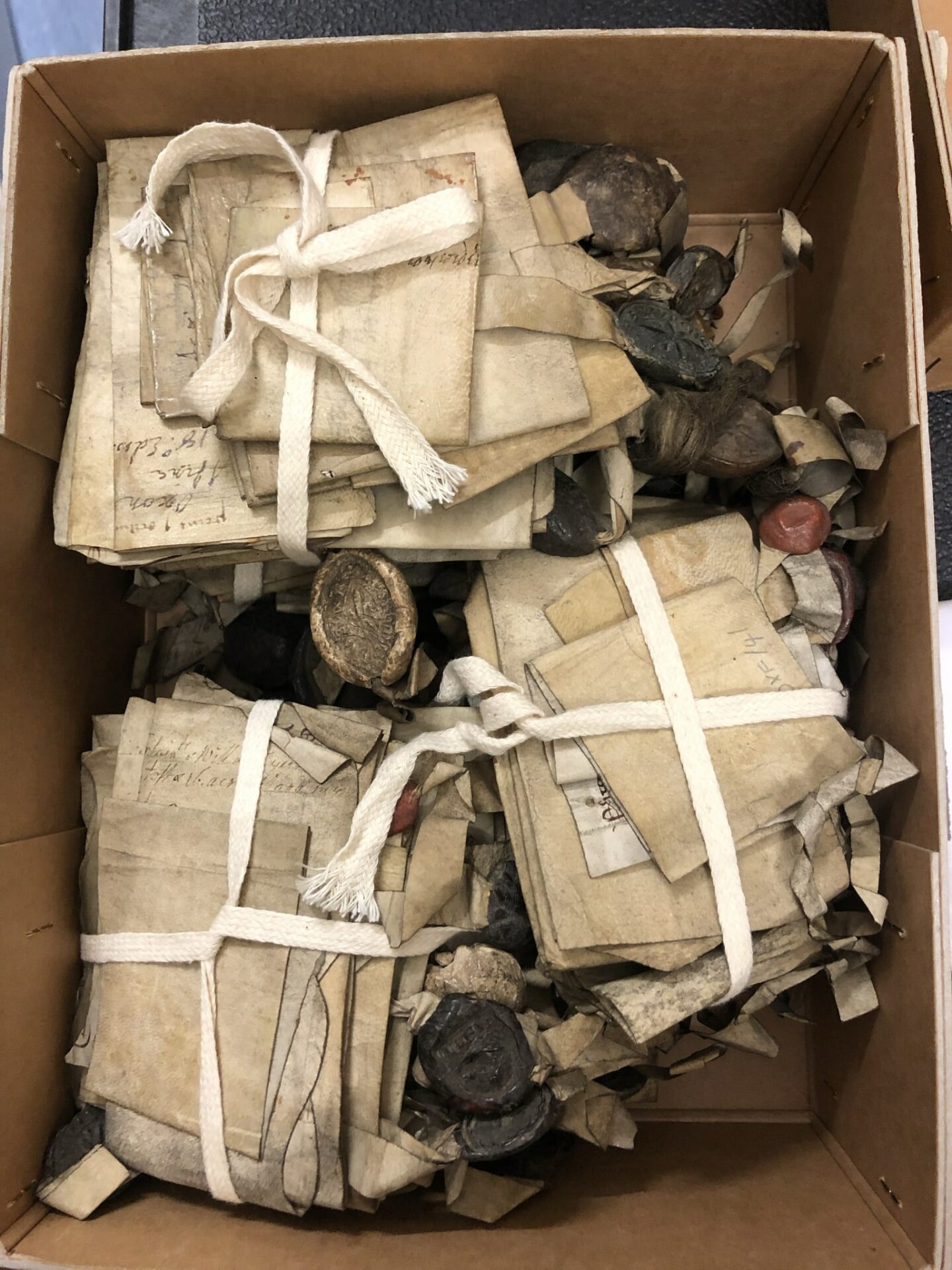 A box full of old charters and other documents