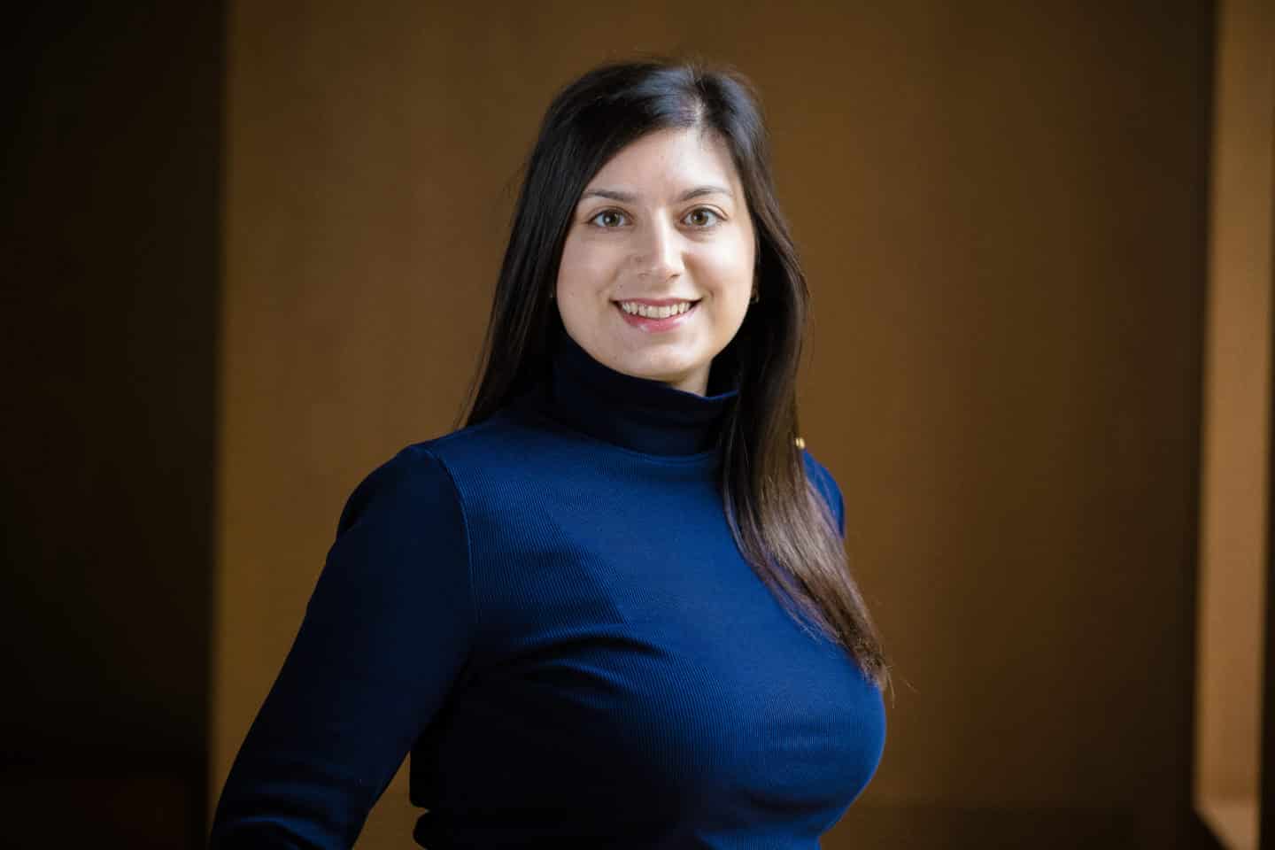 Headshot of Marina Sotiriou, a woman in a blue jumper