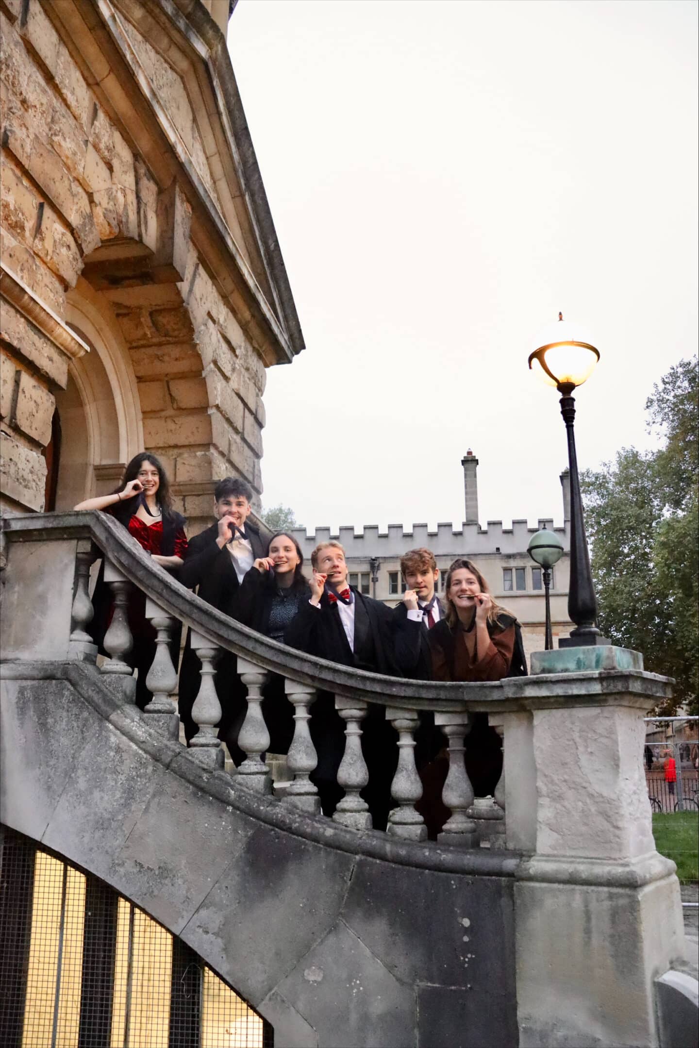 Six members of the Running Club standing behind a stone balustrade