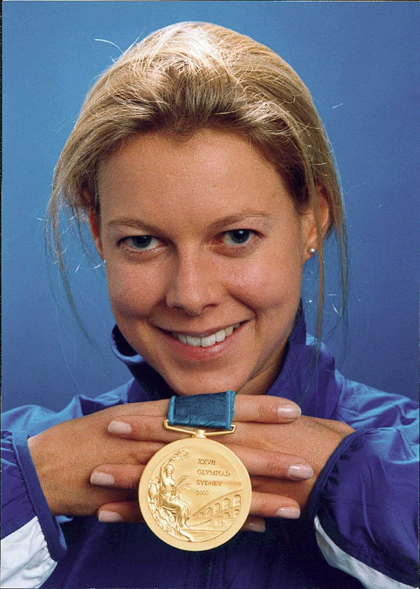 Steph Cook holding Olympic gold medal